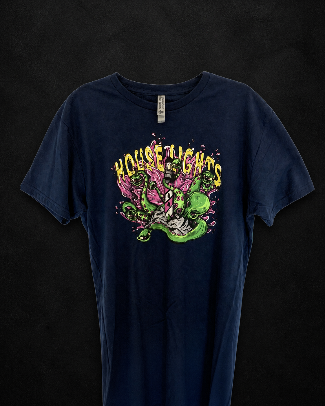 Navy Kraken T-Shirt hanging on a textured black background