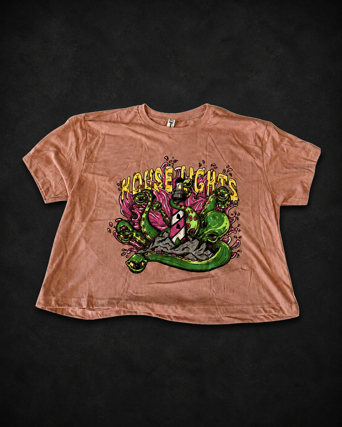 Pink Kraken Crop Top laid flat on a textured black background